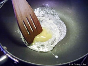 frying an egg in a skillet.