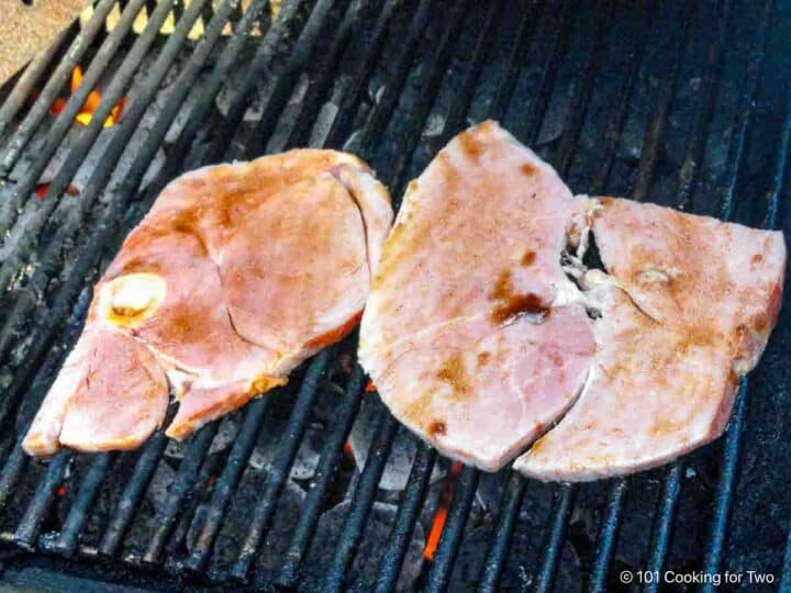 Glazed ham steak on the grill.