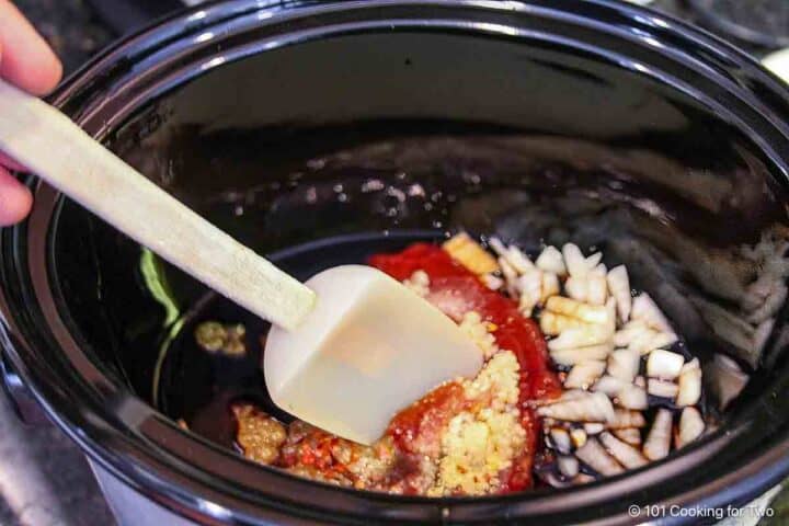 Mixing sauce ingredients in the crock pot.