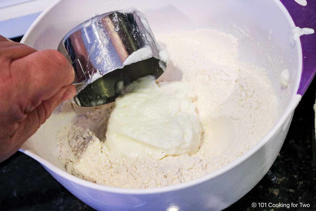 Mixing yogurt into flour mixture.