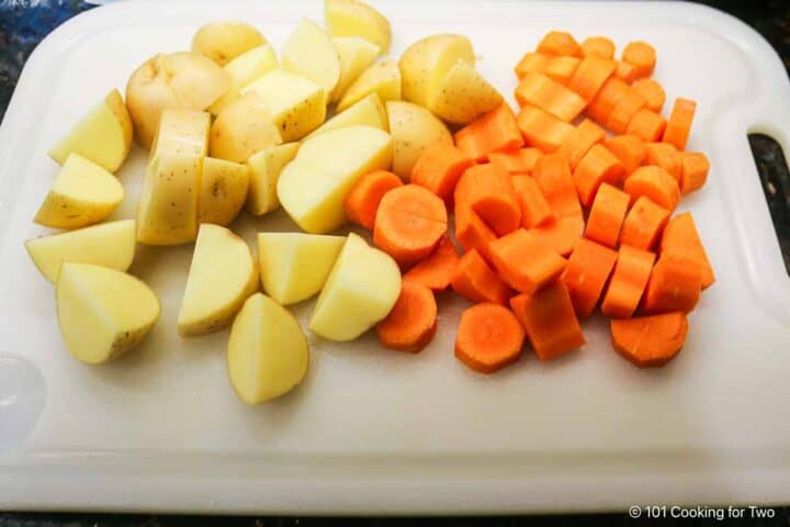 Potatoes cut into chunks and carrots into medallions.