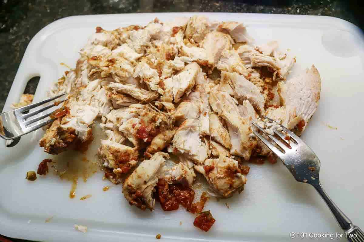 shredding chicken with forks,