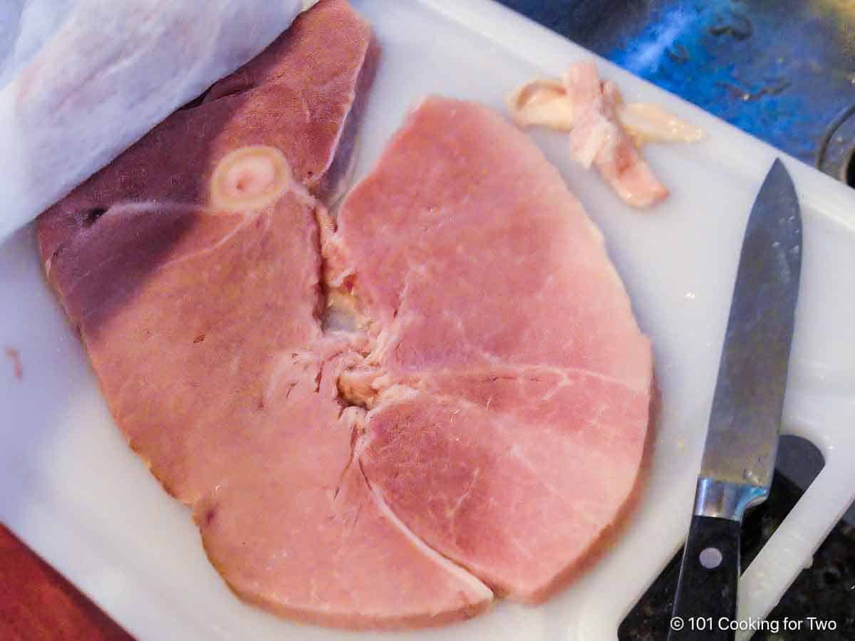 Trimming a ham steak.