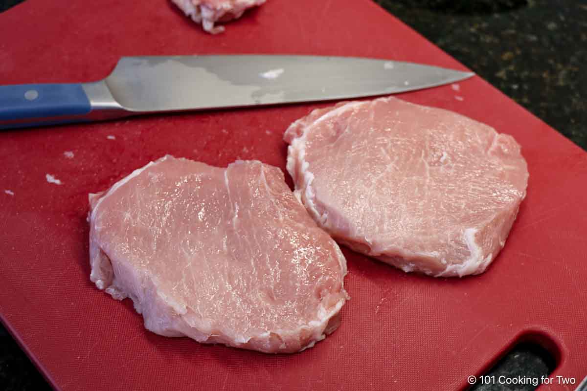 Trimming pork chops.