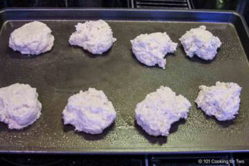 Uncooked drop biscuits on a tray.