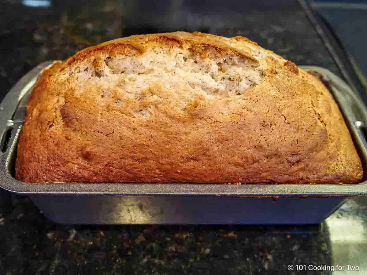 Browned loaf out of the oven in the loaf pan.