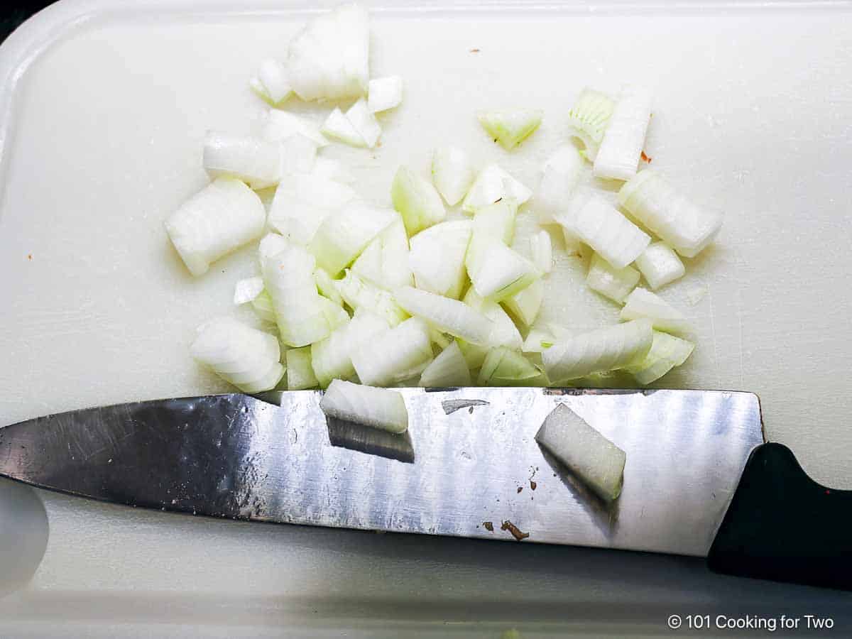 Chopped onion on a white board.