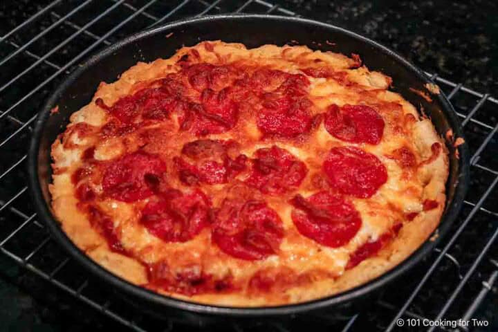 Cooked pizza on a rack.