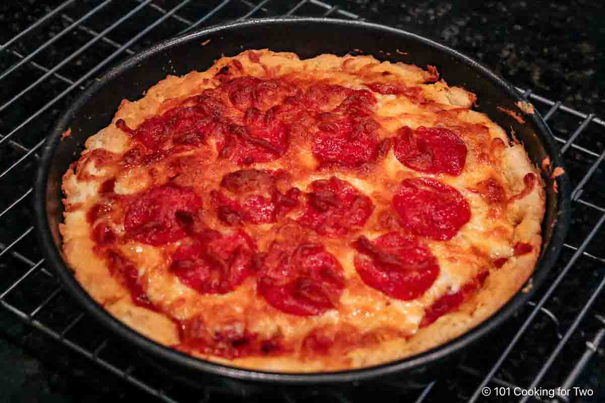 Cooked pizza on a rack.