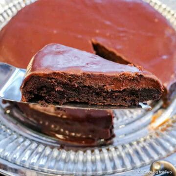 Slice of flourless chocolate ganache cake on a spatula.