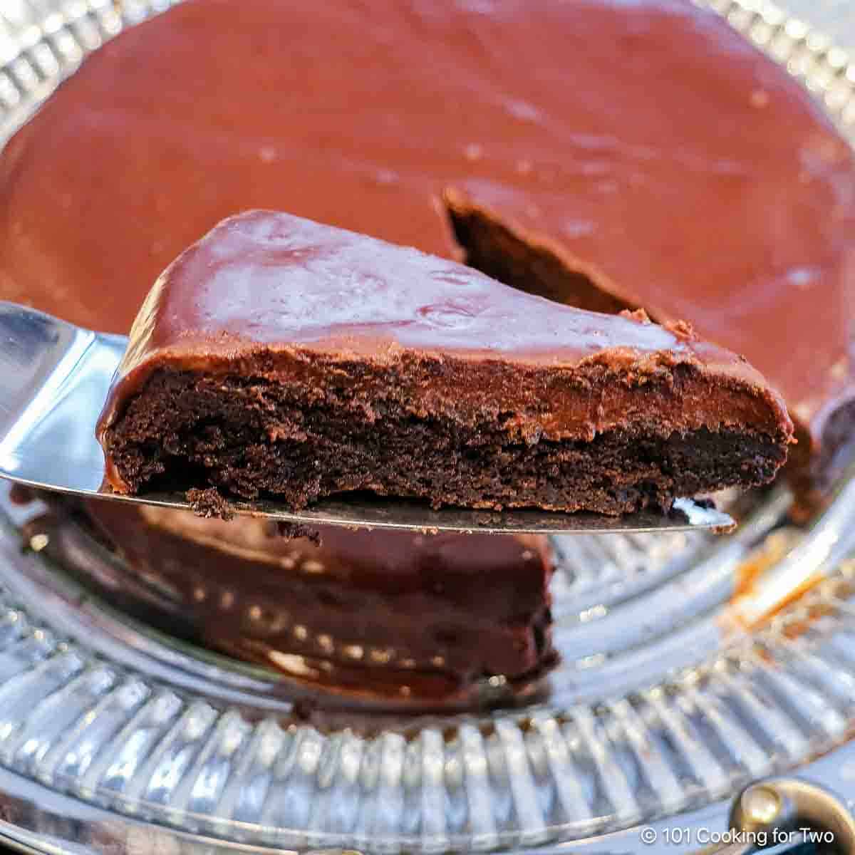 Slice of flourless chocolate ganache cake on a spatula.