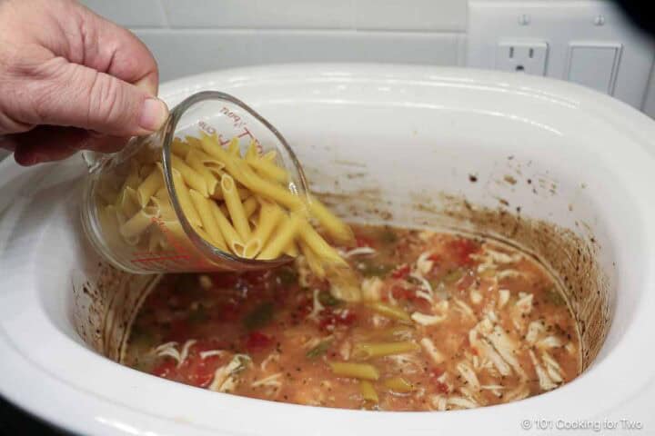 Add shredded chicken and pasta to the crock pot.