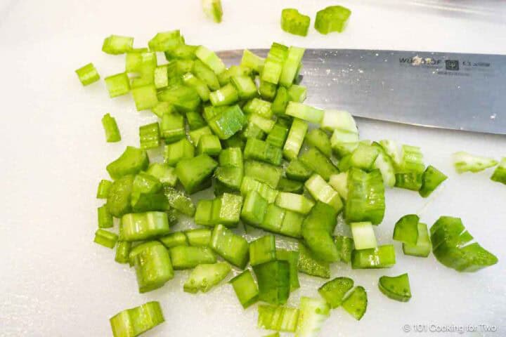 Chopping celery on a white board.