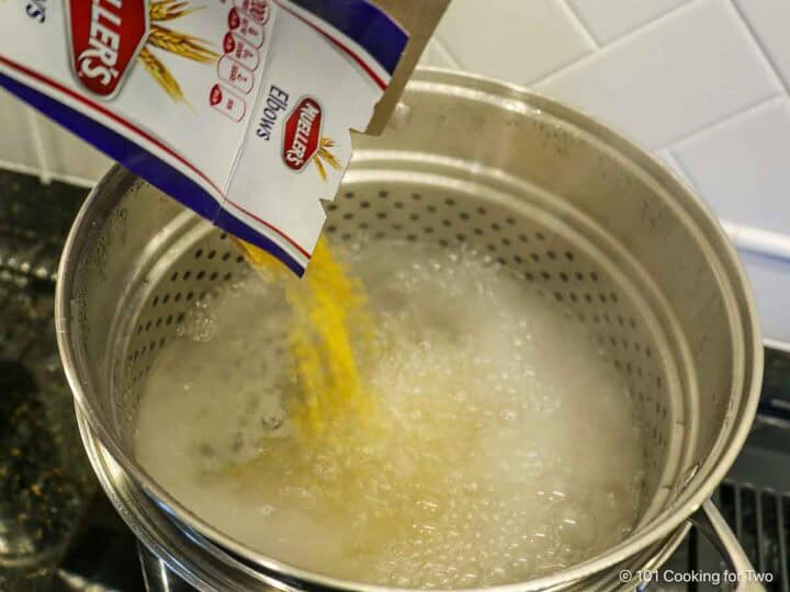 Cooking elbow macaroni.