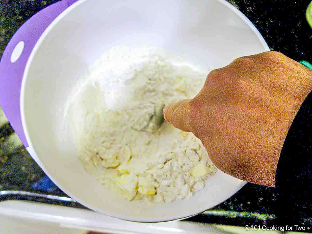 Cutting butter into the dough.