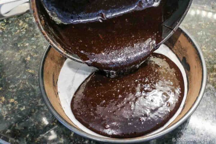 pouring batter into the prepared pan.