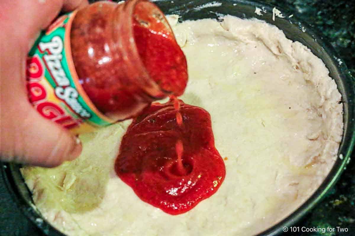 Pour pizza sauce on to the crust.