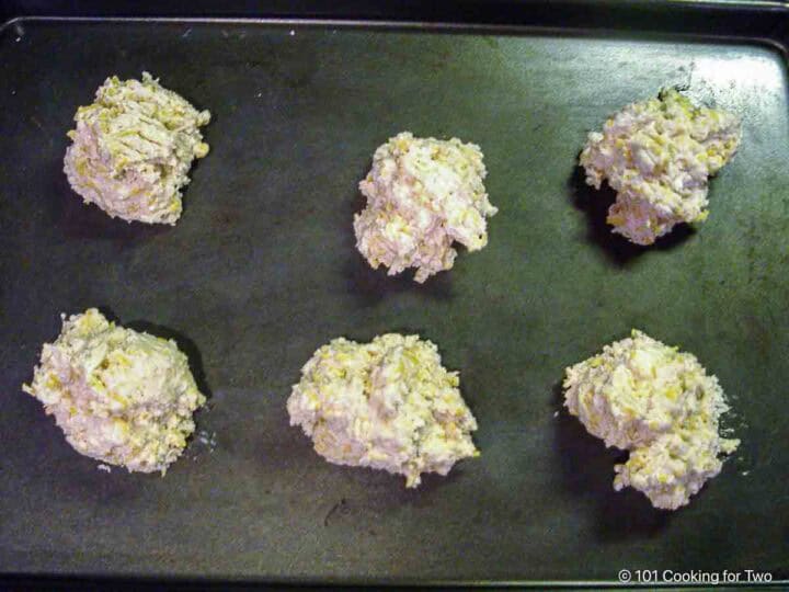 Six biscuits on a baking sheet.