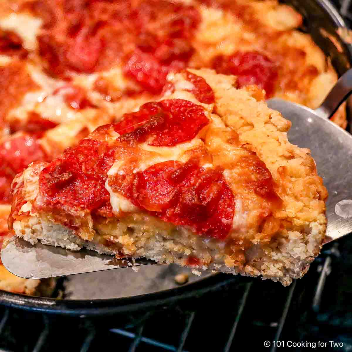 Slice of biscuit pizza on a spatula.