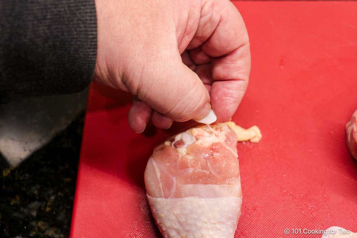 Trimming the chicken leg.